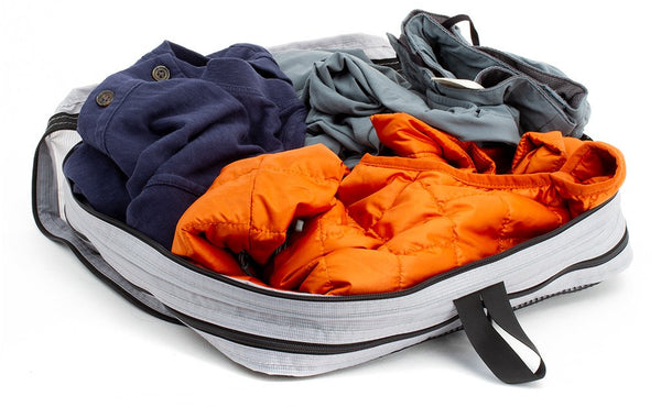 A set of clothes in an open Northwest Sky (light grey) Aether Large Aeronaut 30 Packing Cube all-fabric side up.